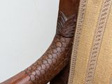 a wooden chair that has a fish on it