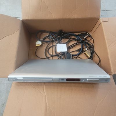 a laptop in a cardboard box with wires on it