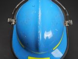 a blue hard hat with a yellow stripe on it