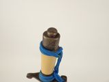 a small wooden pole with a blue rope around it