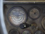 a close up of a car dashboard with a clock and gauges