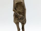 bronze statue of a woman with a hat on her head