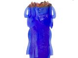 a blue glass vase with a blue dress on it