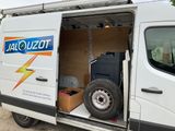 a white van with the door open and a box in the back
