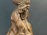 a statue of a rooster with a crown on it ' s head