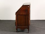 a small wooden cabinet with a marble top on wheels