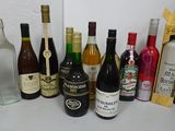 many bottles of alcohol on the counter next to each other