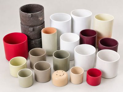 de nombreux verres et vases de différentes couleurs sur la table
