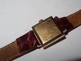 a close up of a watch on a white surface