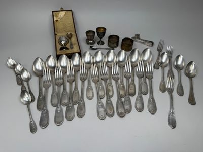 a lot of silver spoons and silverware on a table