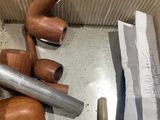 a box with a bunch of wooden pipes and a hammer
