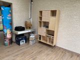 a room with a wooden floor and a blue refrigerator