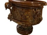 a brown vase that is sitting on a pedestal