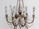 a chandelier that has five lights hanging from it