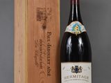 a bottle of wine sitting next to a wooden box