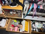 a drawer full of various items in a room