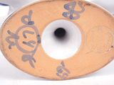 a close up of a ceramic object with chinese writing on it