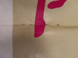 a piece of paper that has a pink tape on it