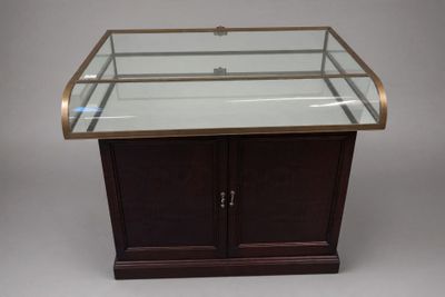 an image of a glass display case with a wooden base