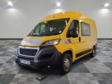 the yellow van is parked on a checkered floor in the garage