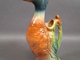 a ceramic duck that is sitting on a table