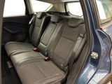 the back seats of a blue car with black seats in the back