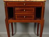 a small wooden table with a marble top and two drawers