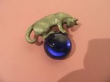 a figurine of a cat on top of a blue ball