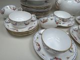 a lot of plates and cups and saucers on the table