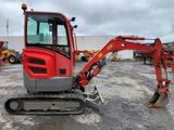 an image of a red excavator parked in a lot