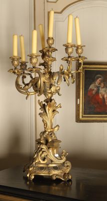 a gold candelab with five candles on a table