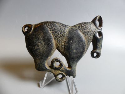 a statue of a horse that is standing on a stand