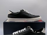 a pair of black and white sneakers sitting on top of a box