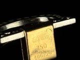 a close up of a gold bar on a black surface