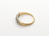 a close up of a gold ring with diamonds on a white surface
