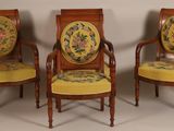 three antique chairs with floral upholstered cushions and a wooden frame