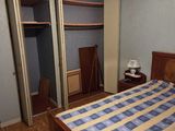 a bed with a checkered comforter in a bedroom