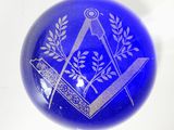 an image of a blue glass ball with a masonic symbol on it