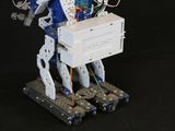 a robot that is holding a box on a stand