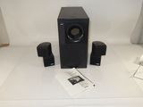 two speakers and a remote on the table