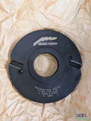 a close up of a black circular object on a piece of paper