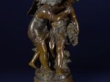 a bronze statue of a boy and a girl on a pedestal