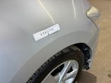 a sticker on the side of a silver car