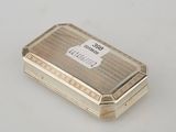 an antique silver cigarette case on a white surface