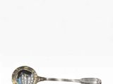 a silver spoon with a blue stone in it
