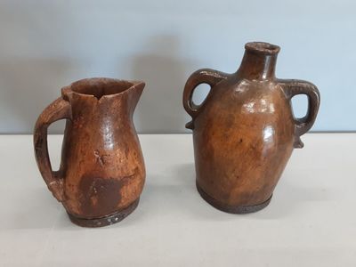 deux vases marron posés l'un à côté de l'autre sur une table