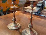 two candles that are sitting on a table in a room
