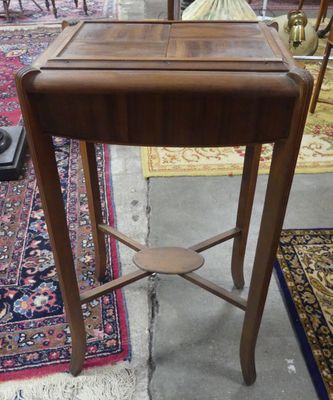 a small wooden table with a lamp on top of it