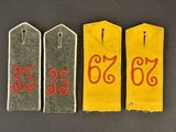 three tags with numbers on them on a black surface