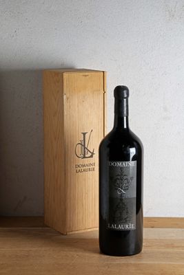 a bottle of wine sitting next to a box on a table